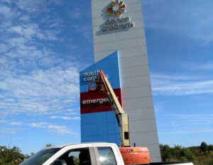 Pressure washing a Business sign